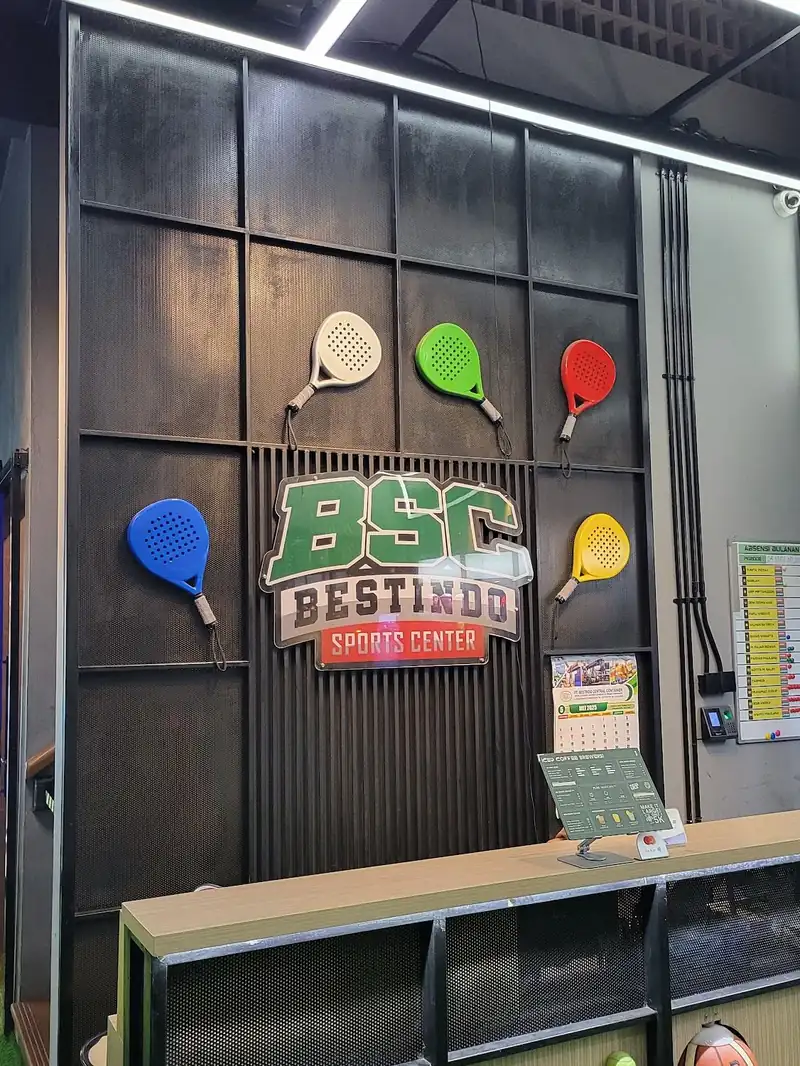 The BSC front desk with padel rackets on the wall