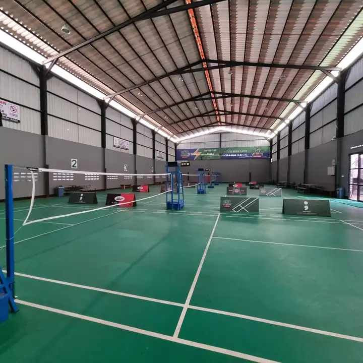 Badminton hall with green courts