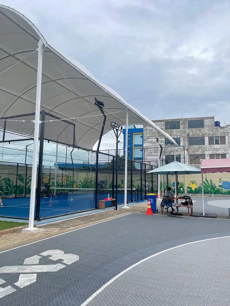 White tensile canopy over the padel courts